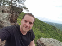 Jared Caldara hikes to the top of in Arkansas